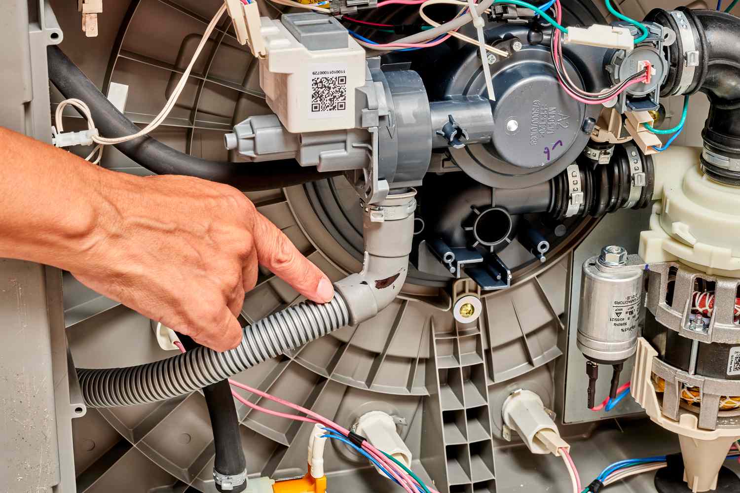 Technician repairing dishwasher with cost estimate